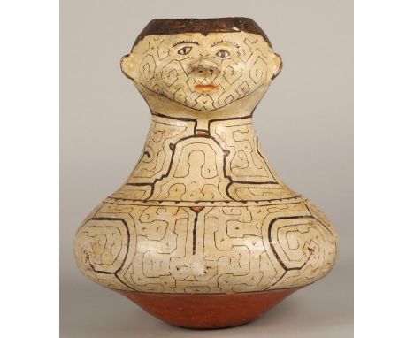 Shipibo terracotta pottery vessel, 20th C, squat base with a tall neck, geometric patterns in brown and red surround two face