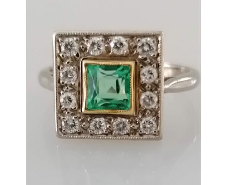 An Art Deco-style white gold platform ring with square-cut emerald, 5mm, surrounded by twelve round-cut diamonds, each approx