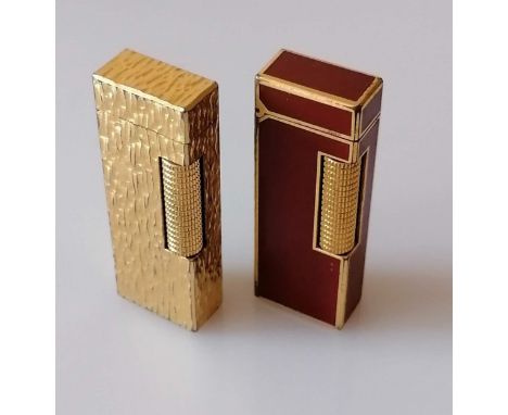 A gold plated textured Dunhill Rollagas lighter, and another with red lacquer, both patent 24163 and Made in Switzerland, lig