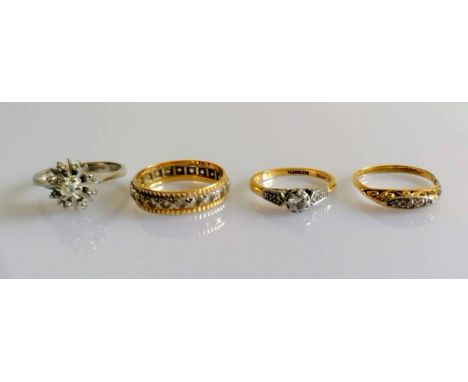 A white gold star-ring with diamond decoration; a white and yellow gold eternity ring; a gold and platinum solitaire ring and