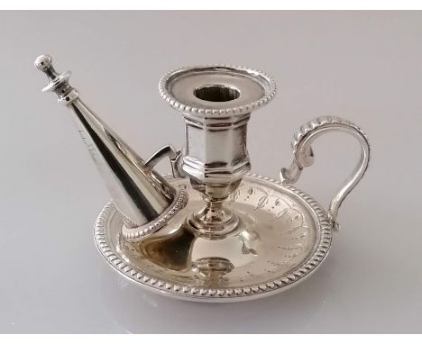 A Victorian silver smaller chamber candlestick with conforming snuffer with beaded decoration on a raised base by George Fox,