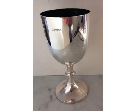 An Edwardian silver chalice or cup of plain form with beaded decoration and knop on a spreading foot by George Howson, Sheffi