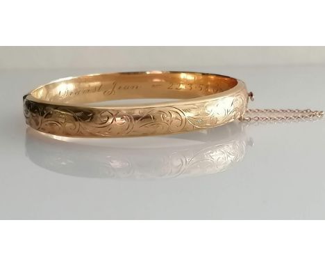 A mid-century 9ct yellow gold bangle with etched decoration, inscription to inside, import marks, 63mm x 56mm internal, 11.5g