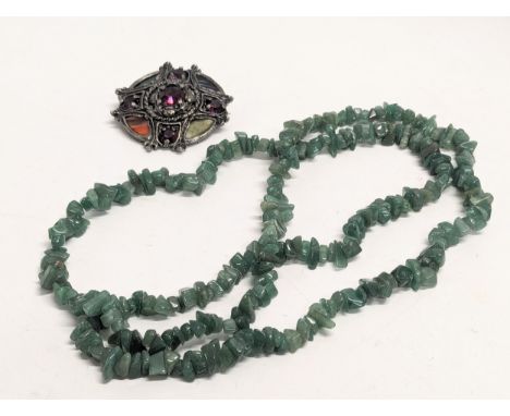 A large jade necklace with a vintage Irish Celtic brooch stamped Miracle. 