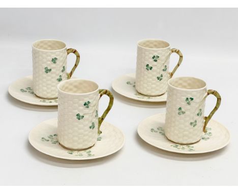 An 8 piece Belleek ‘Shamrock’ coffee service. 1 green stamp mug and 7 brown stamps. Saucers measure 15.5cm. Mugs 9x10cm 