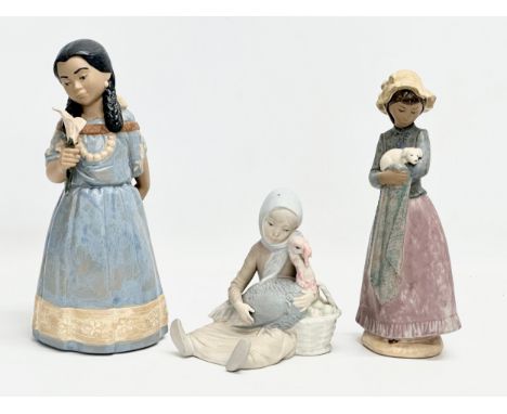 3 Spanish pottery figurines. Lladro, NAO, Nadal. A Lladro ‘Girl with Turkey’ 13x15cm. A NAO ‘Girl with Puppy’ 26cm. A Nadal ‘