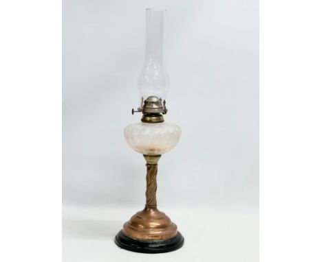 An early 20th century oil lamp with copper and brass column. 60cm 