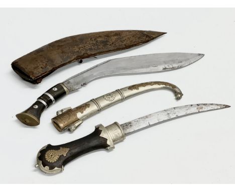 A vintage steel bladed Kindjal dagger with wooden handle and scabbard. Together with a Gurkha style  and leather scabbard. 