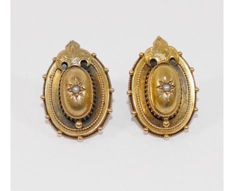 A pair of Victorian hollow gold oval earrings, each centrally set with a half seed pearl, with later stick backs, 2.7cm long,