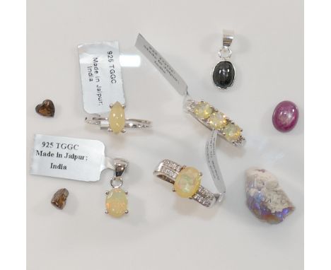 Three modern Ethiopian opal set rings, stamped '925', a similar opal pendant, also stamped '925', loose gem-stones including 