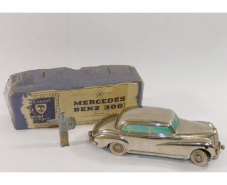 A Prameta Kolner Automodelle clockwork silver Mercedes-Benz 300, 14.3cm long, with original figural key and box lidCONDITION 