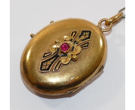 A 19th century French gold oval locket, set with single red stone within inlaid black enamel surround, 4.5cm long including s