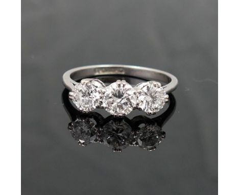 A three stone diamond ring, the round brilliant cut stones approximately 0.45ct, 0.55ct and 0.45ct, visible inclusions, appro