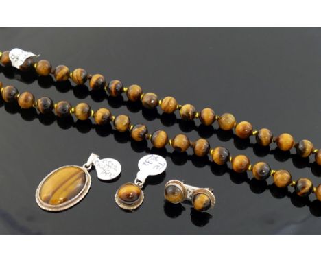 A selection of tiger's eye jewellery comprised of a string of cylindrical beads, a round cabochon suite of earrings, a ring a