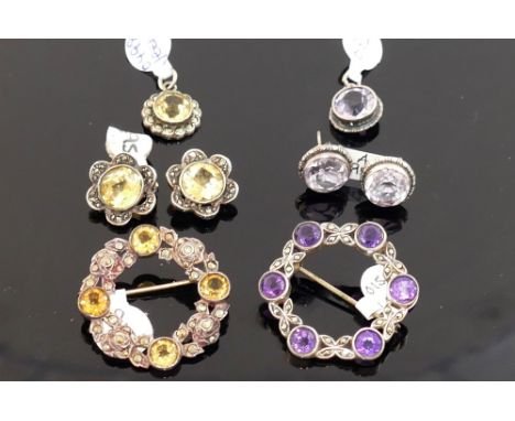 A collection of amethyst and citrine set jewellery, the amethyst jewellery comprised of a circular brooch, also set with marc