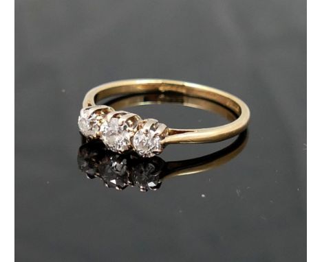 A diamond three-stone ring, the graduated old-cut stones approximately 0.15, 0.23 and 0.15 carats, in claw setting, the shank