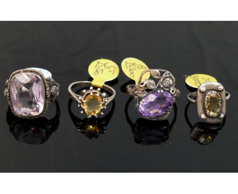 A collection of 12 amethyst and citrine set rings, including some set with marcasite, most stamped 'silver' or '925' of varyi