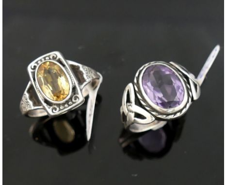 A collection of amethyst and citrine set  jewellery, the amethyst jewellery comprised of a Celtic style brooch and ring, a pe