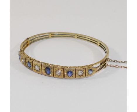 A late19th/early 20th century possibly French sapphire and diamond set hinged bangle, the four old-cut diamonds combined weig