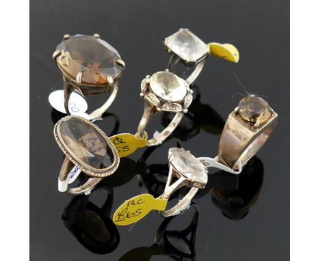 Twelve rock crystal and smokey quartz set rings, most stamped 'silver' or '925', including a marcasite and rock crystal clust