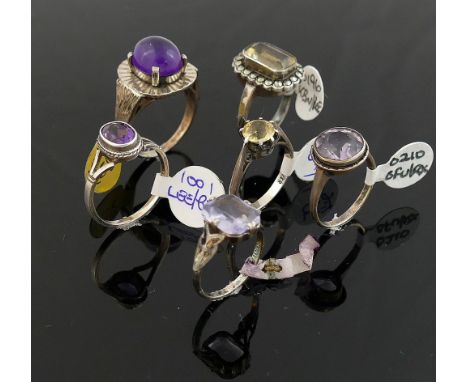 A collection of 12 amethyst and citrine set rings, including some set with marcasite, most stamped 'silver' or '925' of varyi