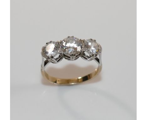 A 9 carat gold diamond simulant three-stone ring, the stones claw-set in white to a yellow shank, finger size N 1/2, 3.6g gro