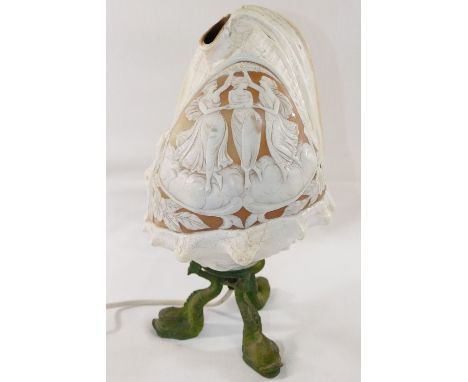 A large Queen helmet conch shell cameo carved with a classical scene of the three graces, mounted to a verdigris bronze lamp 