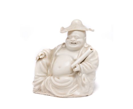 □&nbsp;A CHINESE DEHUA FIGURE OF BUDAI, 18TH CENTURY jovially modelled seated at 'Royal Ease', wearing a floppy hat (damaged)