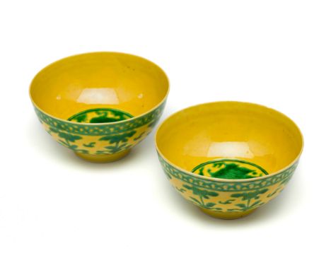 A PAIR OF CHINESE YELLOW AND GREEN 'DRAGON' BOWLS, 20TH CENTURY  each with rounded sides rising from a short tapering foot to