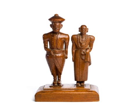 A CARVED WOOD MODEL OF A KANDYAN ROYAL COUPLE, SRI LANKA, FIRST HALF 20TH CENTURY   both wearing traditional dress, the male 