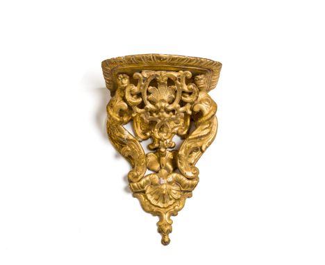 □&nbsp;A GILTWOOD WALL BRACKET, FRENCH, EARLY 18TH CENTURY the ledge with gadroon rim above a pierced scroll and shell backpl