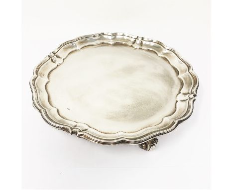 A GEORGE V SILVER SALVER, HARRISON BROTHERS &amp; HOWSON, SHEFFIELD, 1917  shaped circular, moulded rim, on four scroll feet 