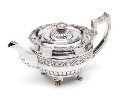 ˜AN IRISH GEORGE III SILVER TEAPOT, ISAAC SOLOMON, DUBLIN, 1817  chased with a girdle of a running ribbon encircling rosehead