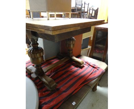 An antique oak extending dining table together with a vintage light oak drawer leaf dining table