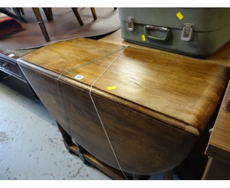 A vintage oak drop-leaf gate-leg dining table