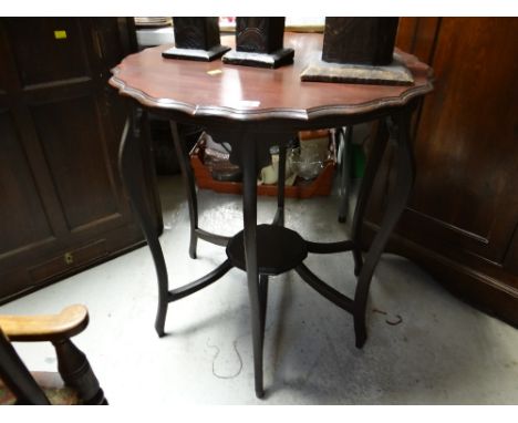 A vintage shaped topped side table with lower shelf