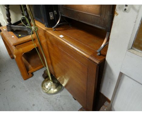 A vintage light oak drop leaf dining table