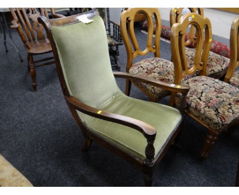 A carved antique button upholstered library armchair