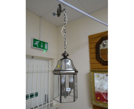 A modern lantern-style drop ceiling light