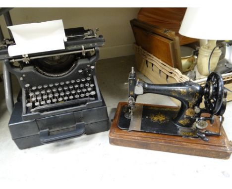 A vintage cased Singer sewing machine together with an Underwood typewriter etc