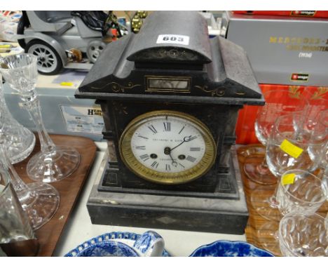 An antique architectural slate mantel clock