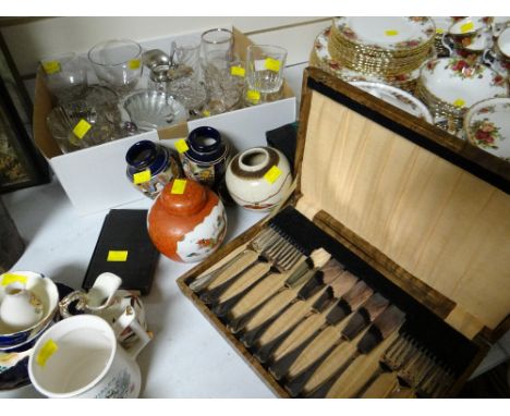 A box of glassware, four Oriental pottery items, cased cutlery & a vintage brass balance scales