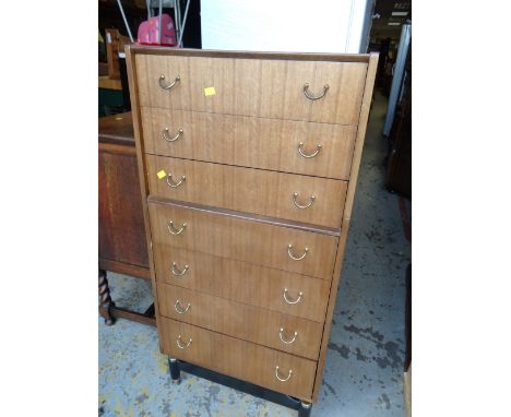 A vintage G-plan tall seven-drawer chest of drawers together with a mirror & frame