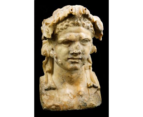 A Dionysian ancient yellow marble herm bust 1st century AD; alt. cm 18; An ancient yellow marble herm male bust with a severe