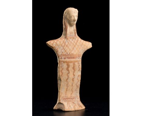 A Boeotian Terracotta figure of a GoddessMid 6th century BC; alt. cm 17,4 ; The solid hand-made body of plank-like form, she 