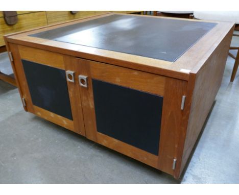 A teak and black vinyl Pandora's box coffee table 