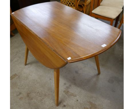 An Ercol elm.and beech Windsor drop-leaf dining table 