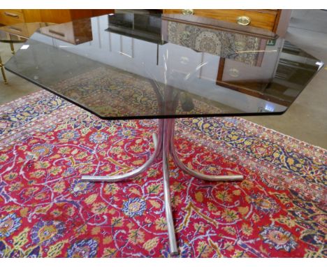 A chrome and hexagonal glass topped dining table 