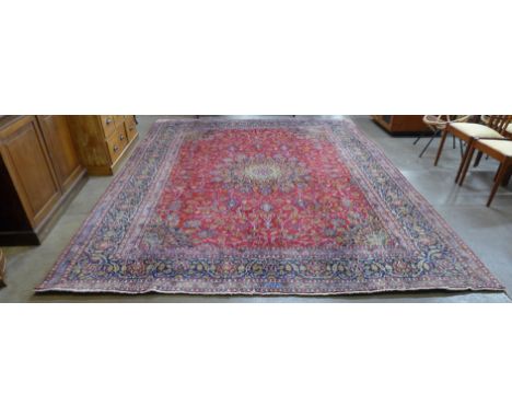 A large vintage Persian Tabriz red ground carpet (388cm x 384cm) 