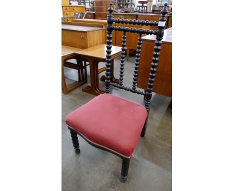 An Arts and Crafts ebonised beech bobbin turned fireside chair 